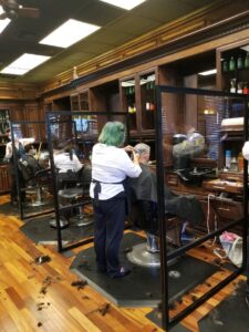A group of people in a barber shop.