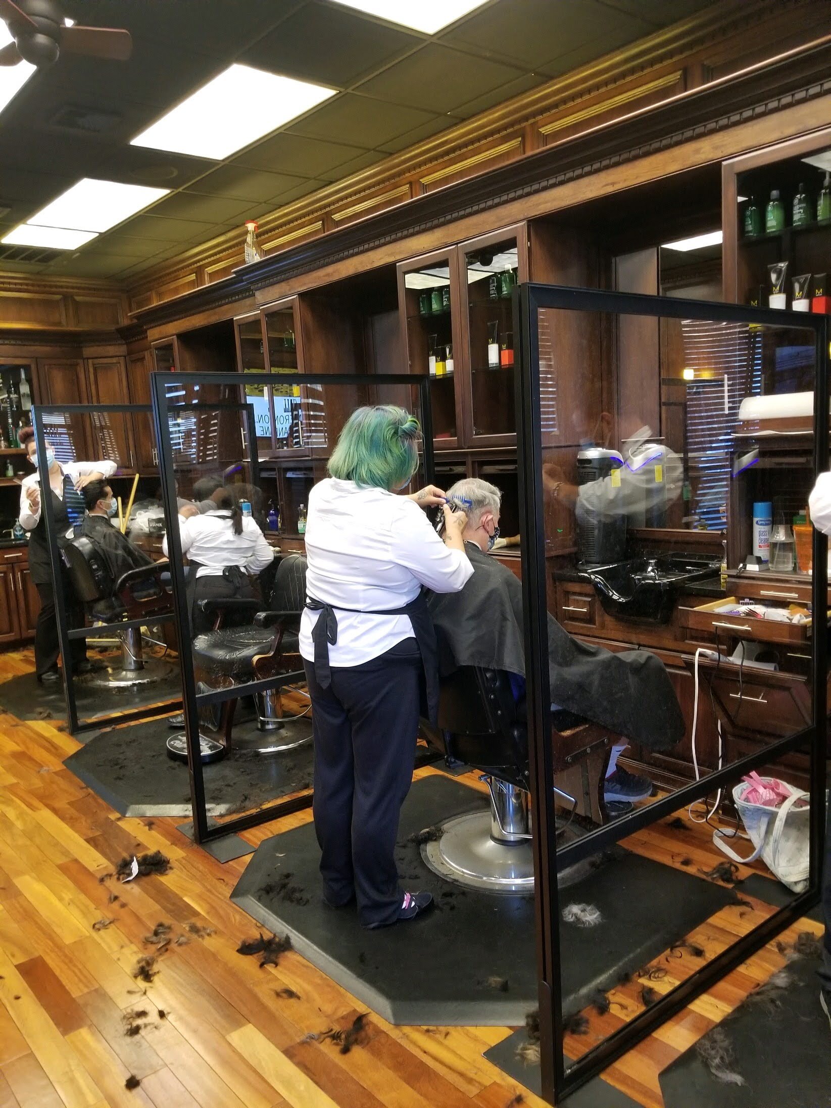 A group of people in a barber shop.