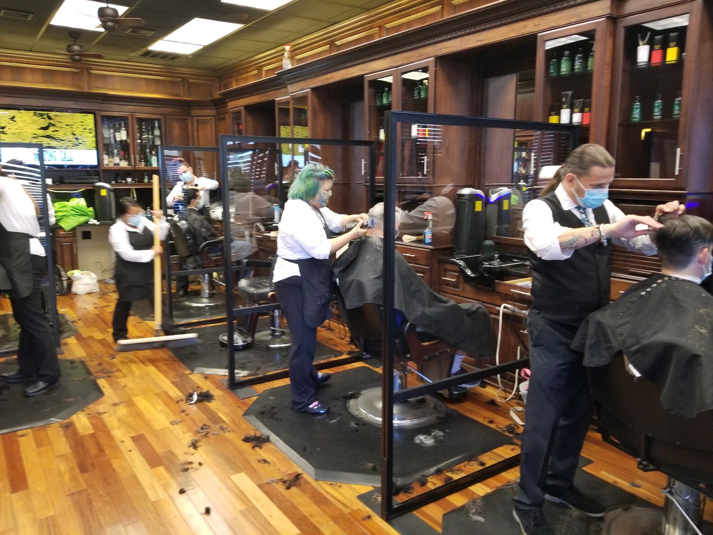 A barber shop with people cutting hair.