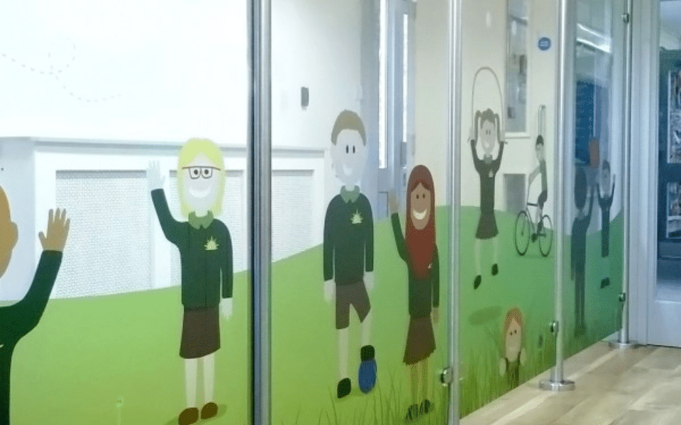 A school hallway is decorated with children's artwork.